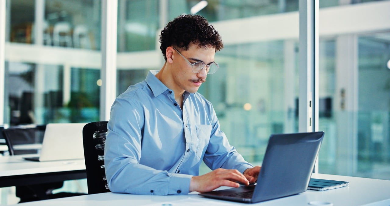 Remote employee accessing cloud document management from a home office laptop