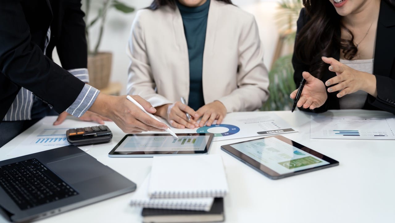 Business team comparing cloud and on-premise document management system deployment options on a whiteboard