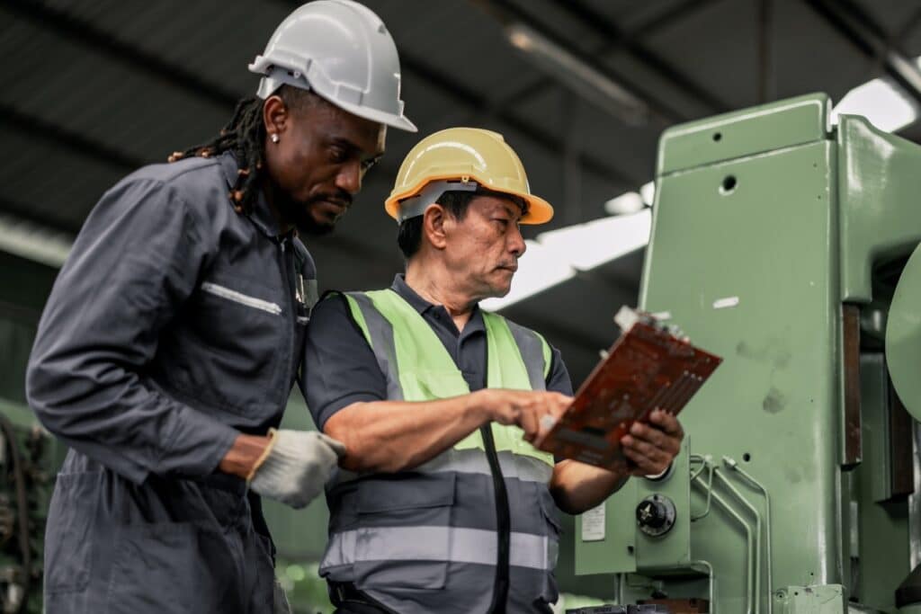 quality technician reviewing calibration certificates linked to equipment records in a document management system