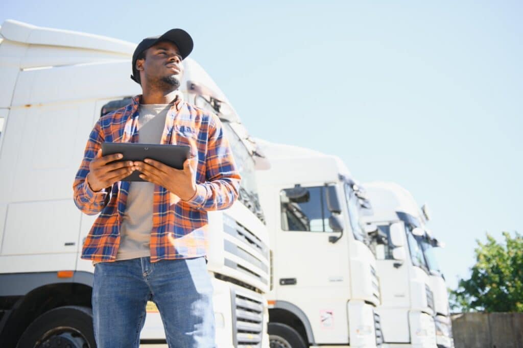 Truck driver capturing delivery paperwork digitally instead of on paper