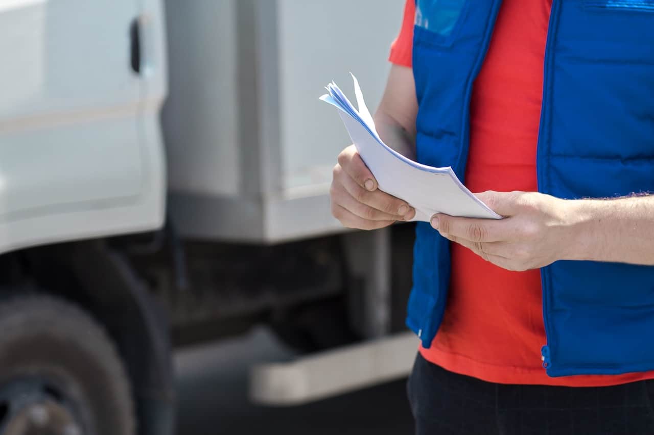 Carrier safety manager organizing driver qualification files for a DOT compliance review