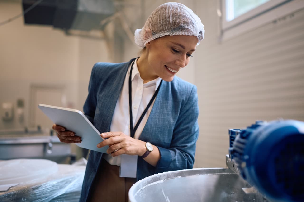 Factory manager using a digital tablet on the production floor with Business Central document control