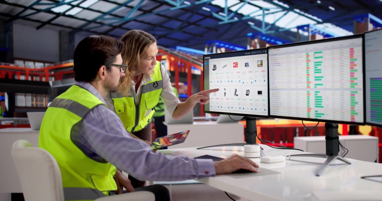 Logistics office staff working at computer screens in a regional carrier back office